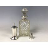 An antique silver-collared cut glass perfume bottle, a silver peperette and a silver thimble