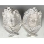 A pair of Baroque style painted plaster wall brackets modelled as busts of Cupid