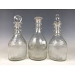 Two Georgian Prussian-bodied glass decanters (one a/f) together with a Georgian club decanter, (with