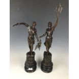 A pair of early 20th Century French bronzed spelter figures entitled La Peche and La Chasse, (one