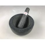 A modern heavy granite pestle and mortar