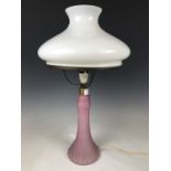 A pink opaline glass lamp base with shade