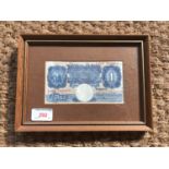 A Bank of England Peppiatt One Pound banknote, framed and mounted under glass