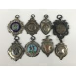 Eight various silver sports prize and other fob medallions, together with an enamelled