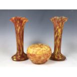 Three items of continental marbled glass, including two vases and a covered dish