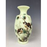 A Victorian hand-enamelled pale green opaline glass vase, decorated in depiction of finches