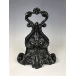 A WB&Co cast iron door stop