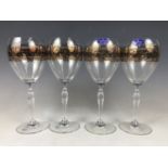 A set of four Royal Doulton crystal and gilded wine goblets