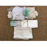 A quantity of early 20th century table linens together with two laundry bags