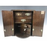 A late Victorian / Edwardian smoker's compendium cabinet in oak