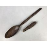 A rustic carved wooden spoon and a turned wood whistle, 36 cm and 13 cm respectively