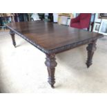 A late 19th / early 20th Century carved-oak wind-out dining table, with one leaf, 183-244 cm x 122