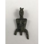 An ancient bronze figural ornament or jewel, in the form of a stylized torso, 42 mm