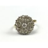 A vintage diamond flower head cluster ring, comprising two tiers of pellet-set brilliant-cut