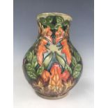 A Moorcroft "Flame of the Forest" pattern baluster vase, impressed and painted marks to base,