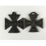 A Great War anti-German mock cast Iron Cross bearing the legend For Kultur, and one other similar