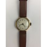 A 1930s lady's 9ct gold cased wristwatch, having a silvered face, Arabic numerals and a faceted