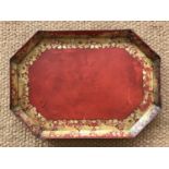 A 19th Century gilt red lacquered papier mache tea tray, of octagon form, decorated with a border of