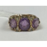An uncommonly large 9ct gold, amethyst and spinel dress ring, having three oval-cut graded