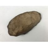 A Palaeolithic stone hand axe, 15 cm