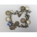 A vintage white-metal charm bracelet and charms, including a Connemara marble clover, and