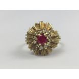 A late 1960s Verneuil ruby and diamond cocktail ring, having a central round-cut ruby of
