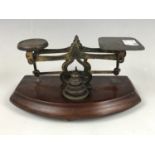A set of 19th Century mahogany and brass postal scales and weights