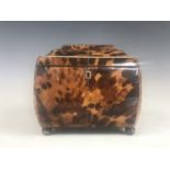 A Georgian tortoiseshell tea caddy, of bombe form, having white-metal and ivory string inlay, a