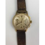A 1960s Iaxa gold plated wrist watch, with stop watch mechanism and tachymeter dial, the circular