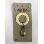 An Elizabeth II baby's silver and ivorine soother / rattle, modelled as a soldier, on original