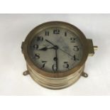 A German Third Reich Kriegsmarine bulkhead clock, the face numbered 6087 N, the back 7812