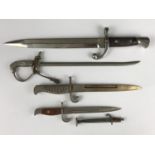 Four early 20th Century miniature bayonets and a miniature sword