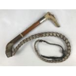 A late 19th Century antler handled riding whip, the handle naively carved as the head of a