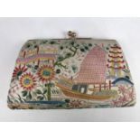 A late 1930s Chinese embroidered silk clutch, decorated in depiction of a junk surrounded by