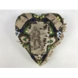 A First World War sweetheart pin cushion centred by a woven depiction of a soldier dressed in khaki