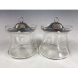 A pair of George V silver-covered blown glass preserve jars, of dimpled tapering form with everted