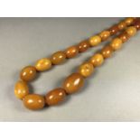 A vintage single strand necklace of graded butterscotch amber beads, 61.2g