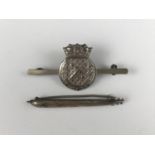 A brooched Royal Navy Mine Sweeping and Anti-Submarine Service badge and a silver torpedo brooch