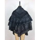 A late Victorian silk cotton evening / opera cape, having couched cord braiding and jet beaded