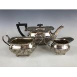 A George V silver three-piece tea set, of Georgian shape, William Hutton and Sons, Sheffield,