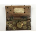 A Georgian wooden cased set of travelling beam scales, with paper label 'Poids des Monncies' [
