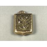A late Victorian 9ct gold Aesthetic Movement locket, the face decorated with a sprig of flowers, 6.