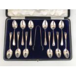 A George V cased set of twelve silver teaspoons and sugar tongs, in the Old English pattern,