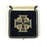 A cased Imperial German 1914 Iron Cross first class, of subtly convex form and with screw-back