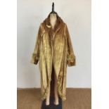 A 1910 - 1920s lady's golden velvet cocoon opera cape retailed by Bradley and Sons of Chepstow