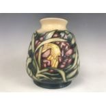 A Moorcroft "Protea" variant pattern baluster vase, impressed and painted marks to base, dated 1999,