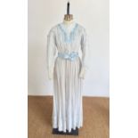 An early 20th Century lady's muslin and powder-blue satin tea dress, of two-piece construction,