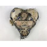 A First World War sweetheart pin cushion centred by a woven depiction of a Royal Navy vessel