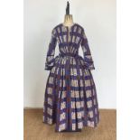 A late 1840s lady's printed cotton-canvas day dress, in a cobalt-blue, white and brown 'watered-