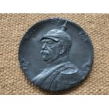 A large early 20th Century German Britannia metal plaque bearing a relief portrait of Otto von